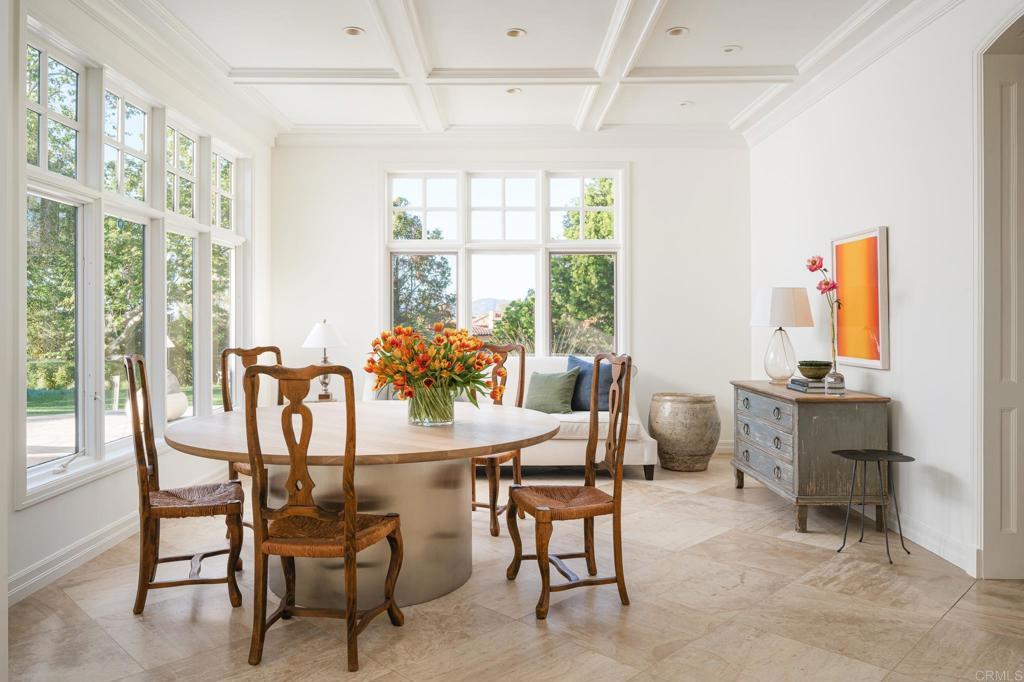 Breakfast room with coffered ceiling and bay-window seating.