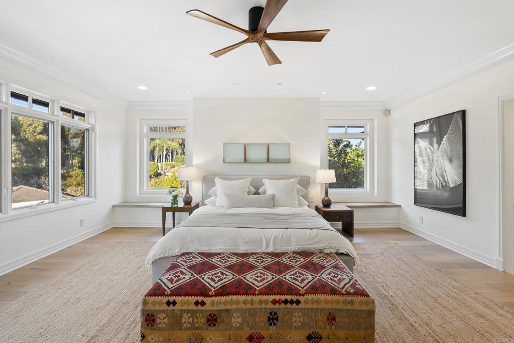 Primary bedroom retreat with bay-window seating and high windows.